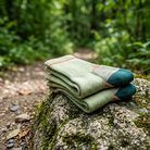 Alpine Merino Crew Socks beside a hiking trail