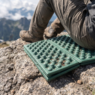 Basecamp Folding Sit Pad in use at a viewpoint